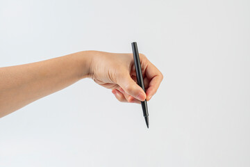 A black pen in hand against a white background.