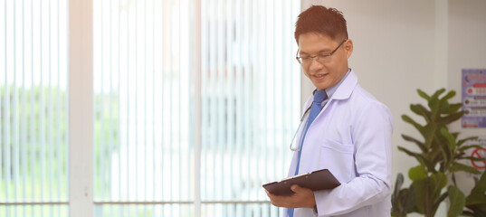Male doctors are discussing checking a patient's temperature at the clinic.