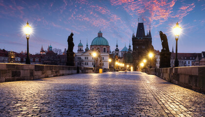 Charles Bridge over River Vltava at dramatic sunrise in Prague, Czech Republic, Europe