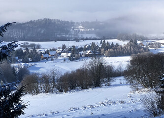 Winter landscape with chalet in nice village in mountain