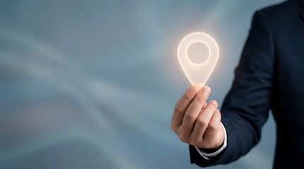 Businessman holding glowing map pin icon, representing GPS location, navigation services, digital map technology, tracking system, and geolocation solutions for modern business and logistics.
