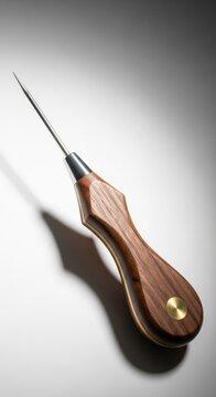 A sharp ice pick tool with a wooden handle sits on a plain background.