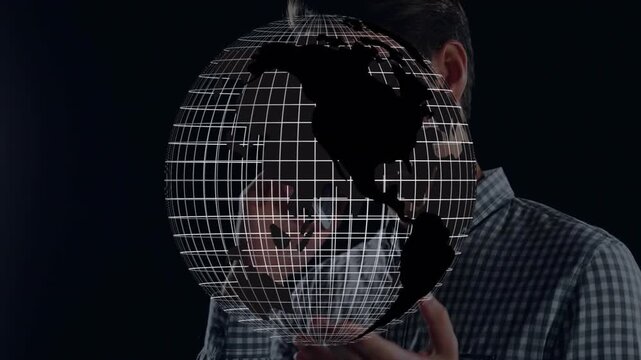 Man interacting with holographic globe in tech studio, showing Americas wireframe map