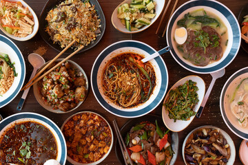 Traditional chinese cuisine serving on a dark wooden table