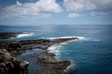Volcanic basalt coastline and turquoise ocean waves in La Reunion island