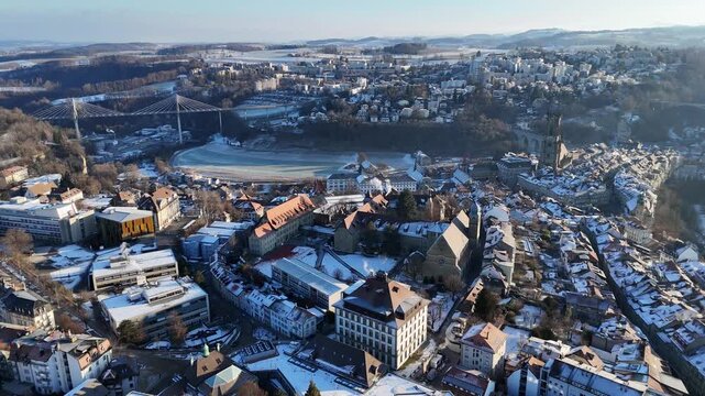 Aerial drone view of Poya Bridge with Fribourg old town and St. Nicholas Cathedral in the background, Switzerland
