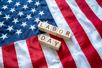 LABOR DAY word made by wooden blocks over United States of America flag