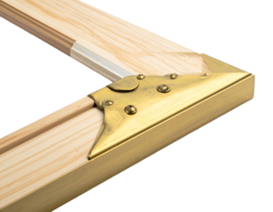 Close-up of a wooden frame corner reinforced with decorative brass hardware