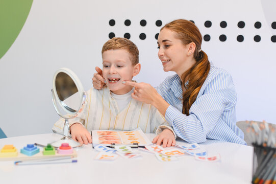 Child practicing speech therapy with logopedist