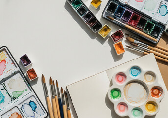 Watercolor Painting Supplies Arranged on White Workspace