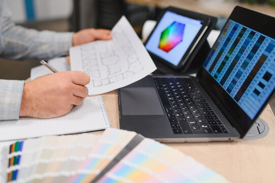 Interior designer working with architectural plan and color palettes