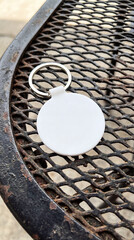 Blank round tag against metal grid with a transparent background