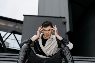 Obraz premium Frustrated young caucasian male expressing anger outdoors in urban setting