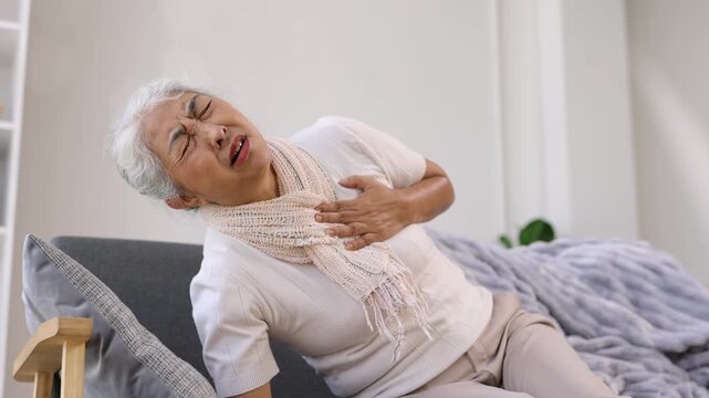Elderly woman suffering from a sudden heart attack.