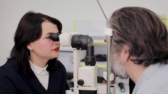 Ophthalmologist conducting eye exam on male patient with slit lamp for vision health check-up