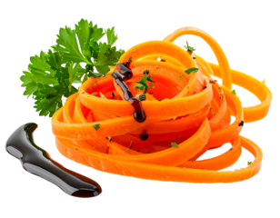 Orange spiralized vegetables drizzled with dark glaze, garnished with parsley