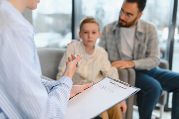 Psychologist counseling father and son discussing family problems