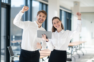 Young managers checking something online and looking excited