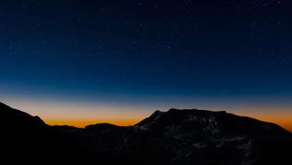 stars in the night sky with the view of mountains.