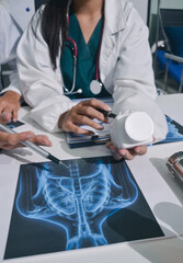 Doctor Explaining X-Ray Results to a Patient Using a Digital Device