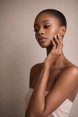 Beautiful african woman touching perfect skin on face