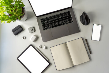 Top view of modern workspace mockups with laptop, tablet and smartphone mockup screens, notebook,...
