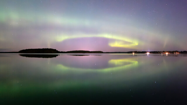 Scenic view at lake against at night. Northern lights dancing after the sunset.
