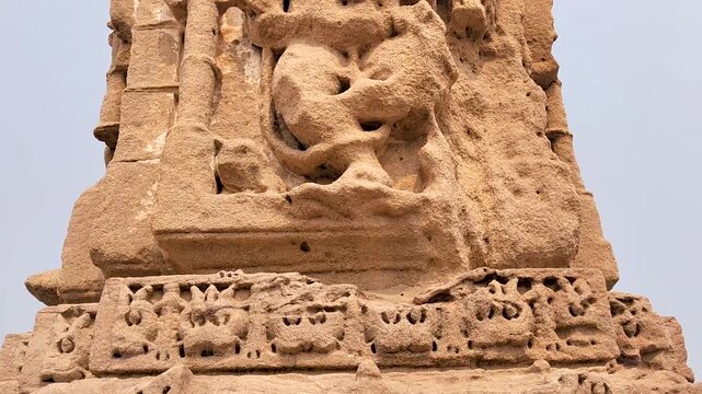 Vadnagar, Gujarat, India ancient Kirti Toran sculpted stone pillar showing large carved human figure, historic Indian architecture, temple era craftsmanship, cultural heritage, and archaeological monu