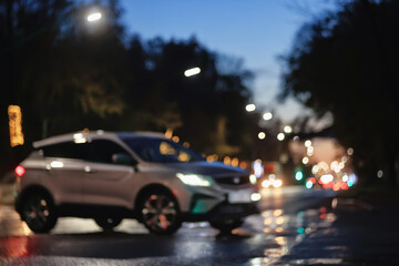 Fototapeta premium Night city blurred background, bokeh in autumn city traffic cars