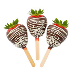 Three chocolate covered strawberries on popsicle sticks isolated on transparent background