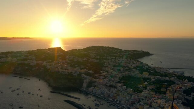 Panoramic drone shot overlooking the Procida island, sunny evening in Italy