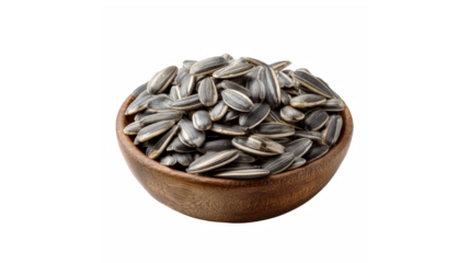 A wooden bowl full of striped sunflower seeds isolated on a black background