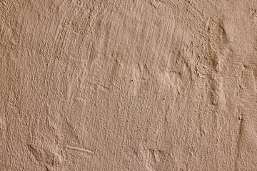 Light beige stucco wall with soft grain and subtle relief, evenly lit and calm in tone. Minimal...