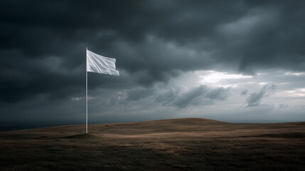 A white flag is on a pole in a field