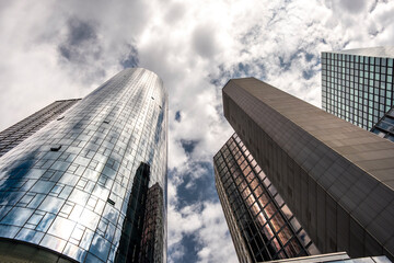 Frankfurt Germany skyscraper architecture corporate glass tower perspective clouds urban skyline viewed from below for modern business district atmosphere