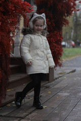 Girl in autumn style, 6 years old child outside in autumn clothes
