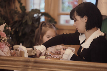 Mom daughter and grandma have a family holiday dinner in a cafe