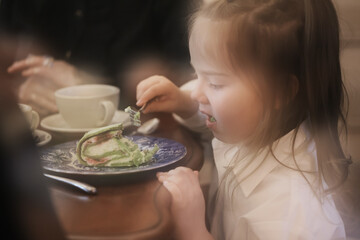 Mom daughter and grandma have a family holiday dinner in a cafe