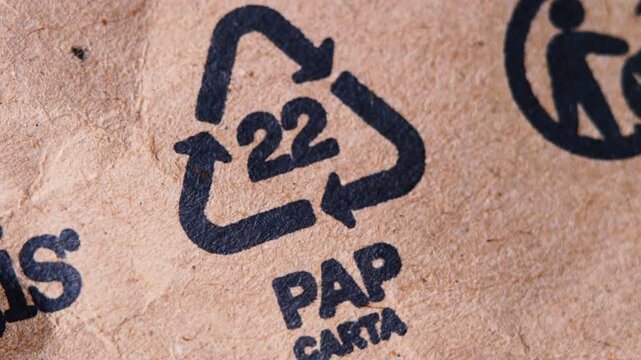 Detailed view of recycling triangle with number 22 on brown craft paper. video represents sustainability, eco-friendly packaging. Suitable for educational videos, green product presentations