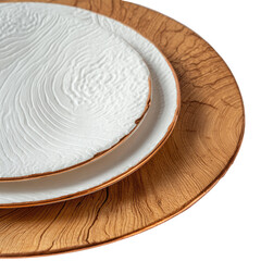 Textured white plate atop wooden charger with contrasting trim on black