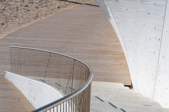 Modern architecture stairs and ramp in concrete with wood surface shaping a curve for minimalism design and abstract copy space layout