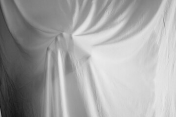 silhouette of a person against the background of a white sheet, the effect of a statue or a ghost