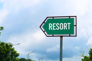 Fototapeta premium Resort Road Sign with Dramatic Clouds and Sky.