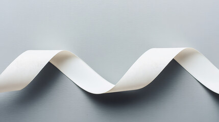 drape. A white ribbon curving downward against a minimalist gray background. wellbeing guides, coaching materials, designed for mental health education and mindfulness programs, clarifies learning.
