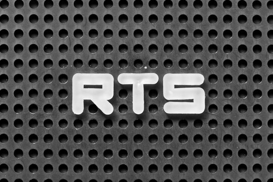 White alphabet letter in word RTS (abbreviation of return to sender, real time strategy, ready to ship or request to send) on black pegboard background