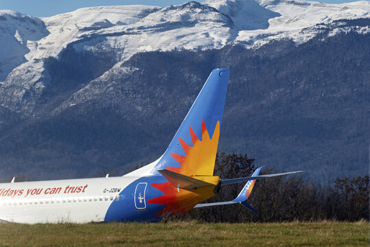 Geneva, Switzerland - january 03, 2026 : signs and logotype on Boeing 737-36Na of Jet2 at Geneva Airport with Snow-covered Jura mountains 