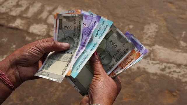 Indian women counting Indian currency notes, Indian rupee 500 notes.