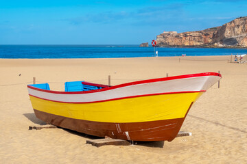 Fototapeta premium Fishing boat on beach of Nazare. Portugal