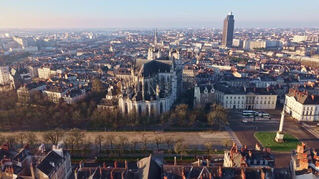 Aerial drone view over Nantes city center shows the Saint Pierre and Saint Paul Cathedral near Place Mar&eacute;chal Foch and the Louis XVI Column, with Tour de Bretagne and Saint Nicolas Basilica visible