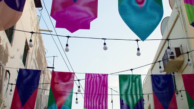 Narrow alley in Muharraq with colorful bunting